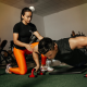 A Personal Trainer Assisting a Client in a Gym Setting